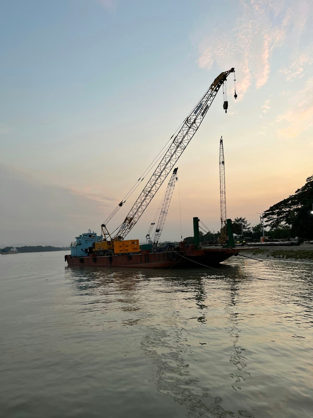 Crane lifting a boat clear of the water