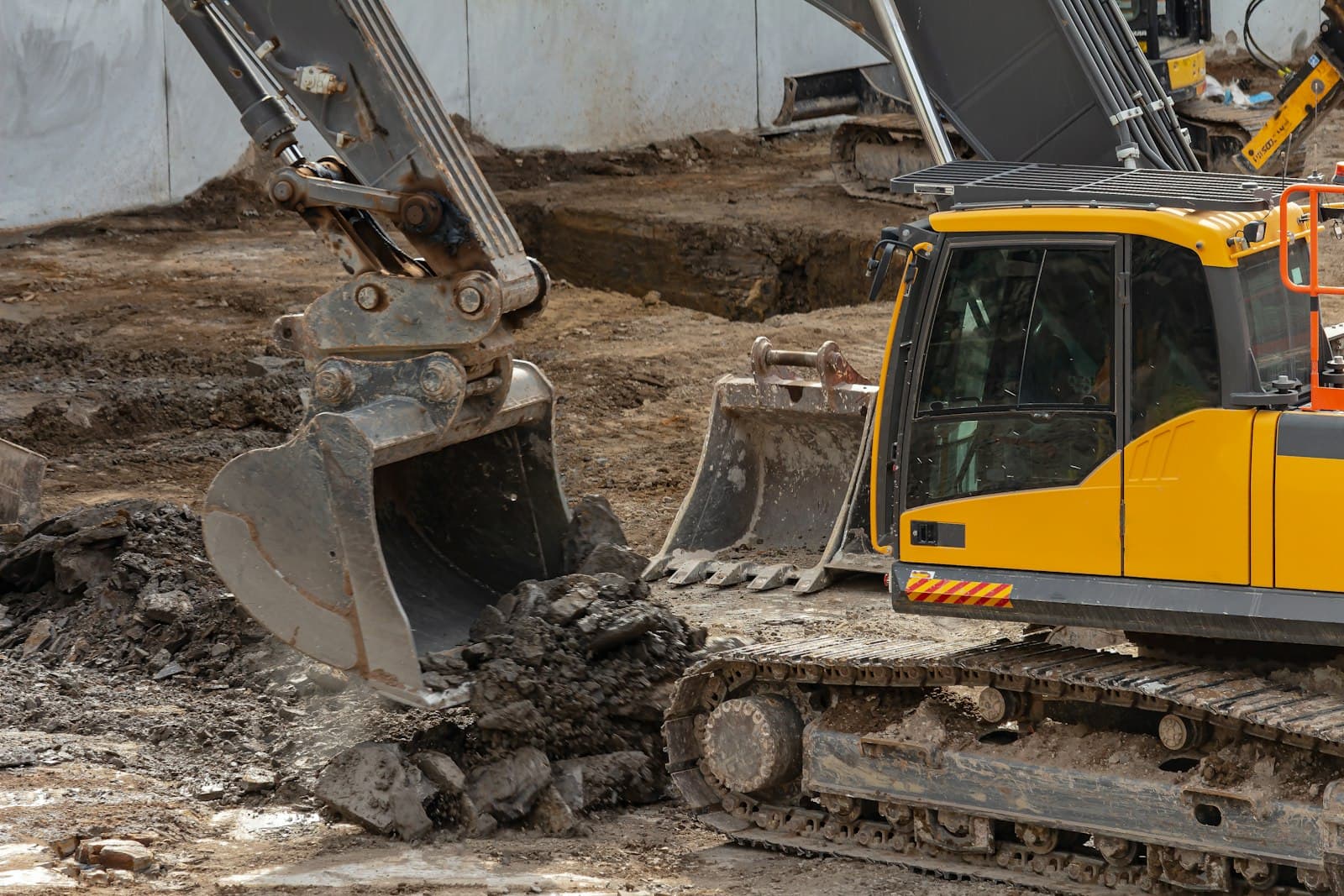 Excavators bucket-to-bucket on an earthworks site